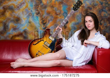 Podolsk, Russia - February 21, 2017: Young brunette girl with a vintage electric guitar Gibson es-345 1969 model year