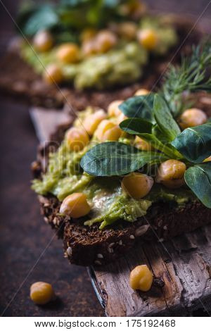 Vegetarian sandwiches on a wooden stand partial blur vertical