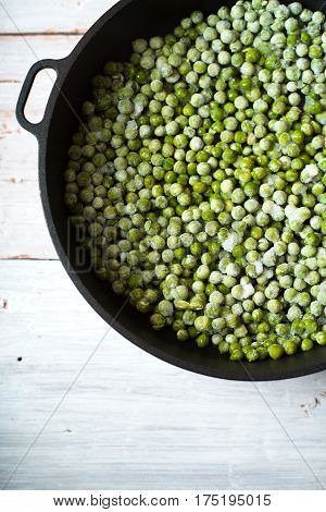 Green beans mung beans in a saucepan on white boards vertical