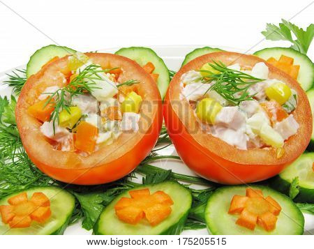 stuffed red tomato with cucumber carrot and parsley