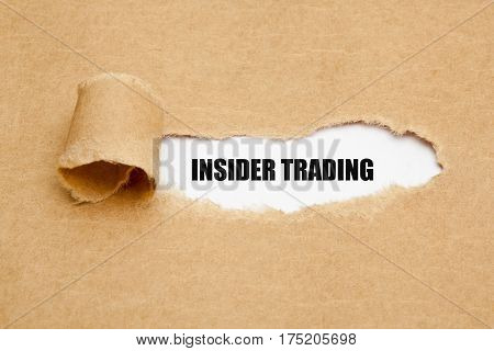 Text Insider Trading appearing behind ripped brown paper.