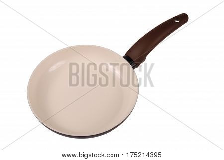 Photo of brown ceramic frying pan isolated on white background with soft shadow. Clipping path