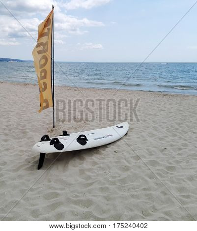 White windsurfing board lying on the banks of the sea The best place for learning windsurfing. Summer training wind surfing.