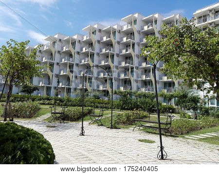 A beachfront hotel with a beautiful park