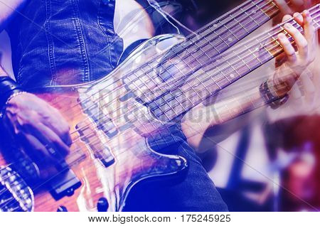 Guitar neck close-up on a concert of rock music in the hands of a musician. guitarist player