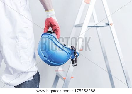 Hard Hat Construction Safety. Construction Worker with Construction Helmet in Hand.