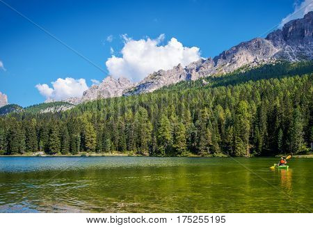Scenic Kayak Touring on the Italian Alps Lake. Caucasian Outdoor Man in the Kayak.
