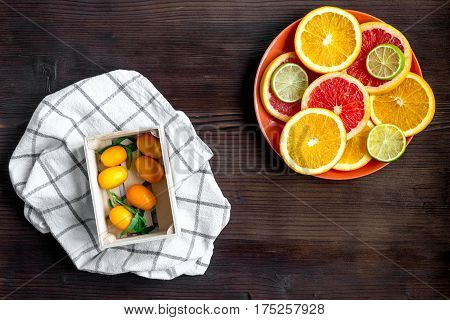 fresh sliced citrus fruits on wooden kitchen table background top view mockup