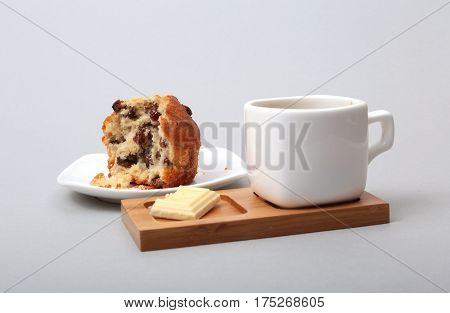 Classic espresso in white cup with cake and chocolate on white background