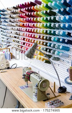 Sewing machine with colorful thread in tailor shop