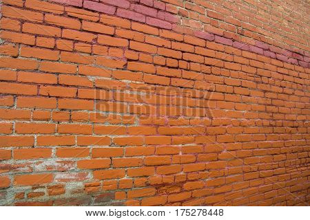 Textured wall with orange, brown and pink bricks