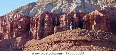 Young woman meditating in rock desert. Capitol Reef National Park. Kanab. Escalante. Utah. United States.
