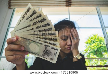 Money In Hand With Statement Paper And Feeling Stressful. In Finnancial Concept