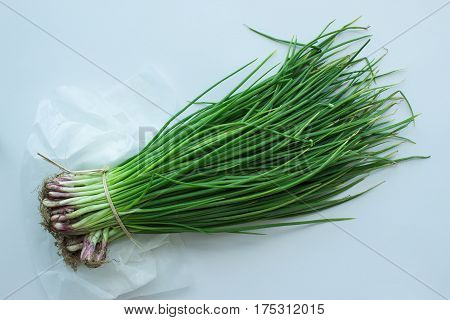 Bunch of green onions with chives on white background
