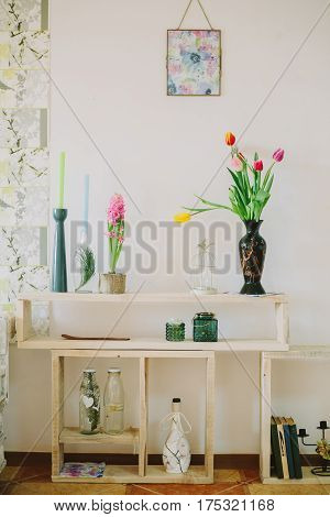 vase with tulips and candlesticks in spring backgroud.interiror