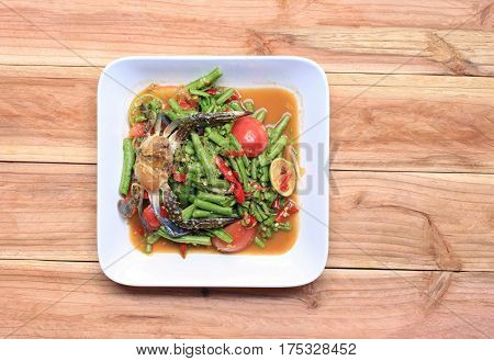 yardlong bean salad with crab of thai foods in white dish on wood background SOMTUM is food of popular in Thailand.