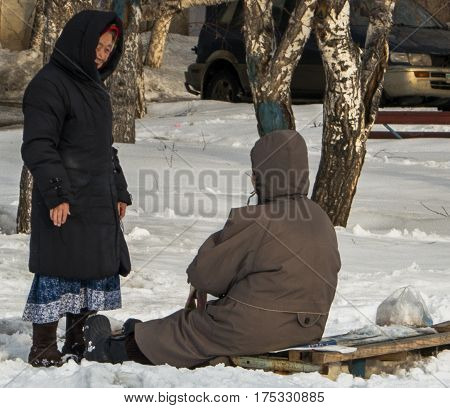 Kazakhstan, Ust-Kamenogorsk, 24 february, 2017: In the courtyard, two elderly women talking