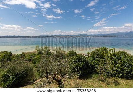 Landscape of the coast of Sirmione peninsula which divides the lower part of Lake Garda. It is a famous vacation place for a long time in northern Italy.