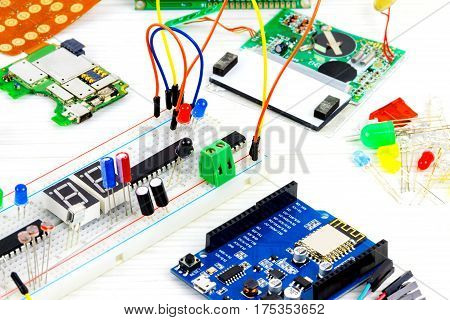 Microcontrollers chips resistors and light-emitting diodes on white desktop of hardware engineer. Engineer workplace