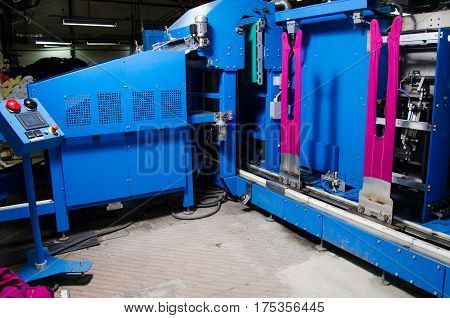 Cotton Yarn Production in a Textile Factory.Textile fabric manufacturing machines in work. Hoisery