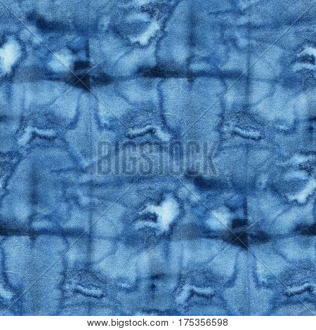 Seamless tie-dye pattern of indigo color on white silk. Hand painting fabrics - nodular batik. Shibori dyeing.