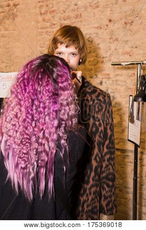MILAN ITALY - FEBRUARY 25: Gorgeous model poses in the backstage just before Cividini show during Milan Women's Fashion Week on FEBRUARY 25 2017 in Milan.