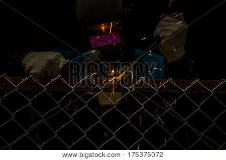 Workers are welding steel mesh in the work area.