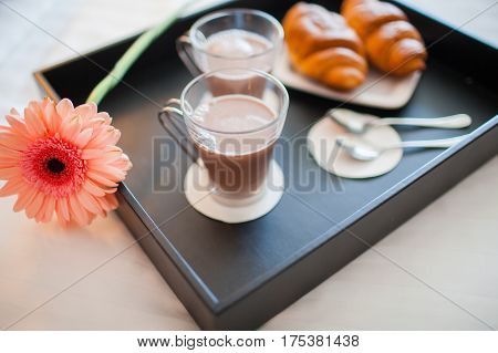 Breakfast tray in bed in hotel room.