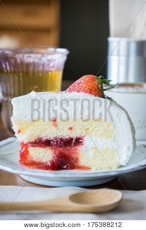 coffee cup and delicious cake strawberry and relax time moblie on table in coffee shop