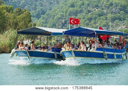 MUGLA, TURKEY - AUGUST 13, 2009: Unidentified tourists enjoy river cruise by the Dalyan river in Mugla, Turkey.