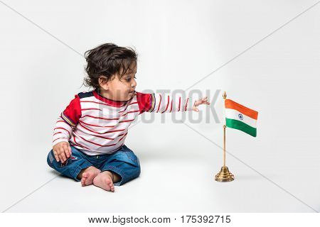 Cute baby boy on white background with indian flag or tricolour