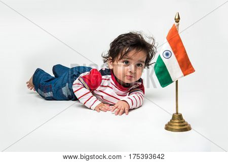 Cute baby boy on white background with indian flag or tricolour