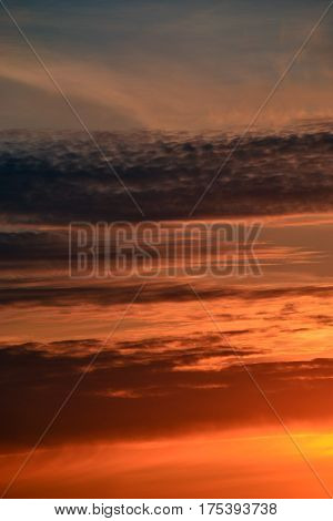 Purple clouds in the orange sunset sky