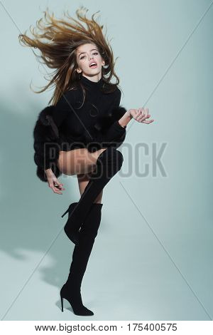 Pretty Sexy Woman With Long Hair In Fur And Jackboot