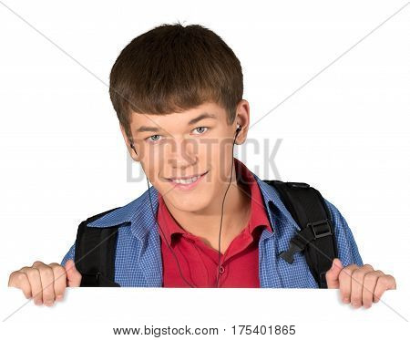 Teen male preppy wearing headphones peeking over invisible object