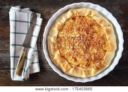 Onion cheese pie on wooden table. Top view