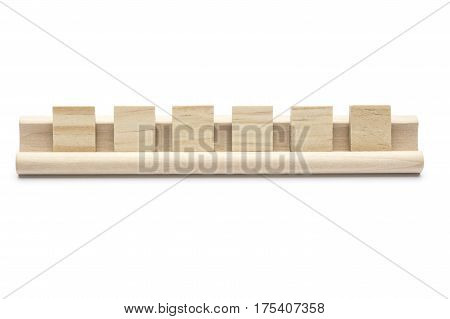 Six blank wooden tiles on a rack isolated on white background.