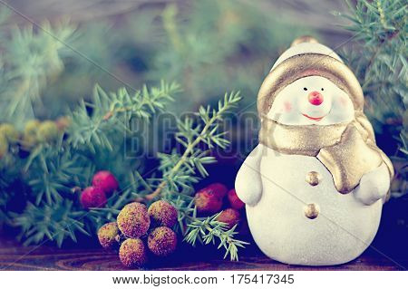 Christmas decoration: Cute Christmas Snowman figurine and Christmas tree bbranches