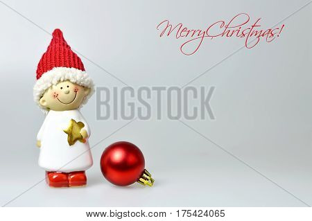 Merry Christmas card with Christmas elf figurine and Christmas ball