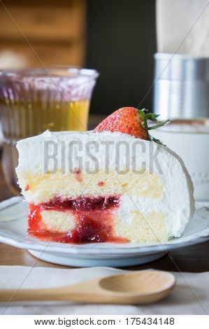 coffee cup and delicious cake strawberry and relax time moblie on table in coffee shop