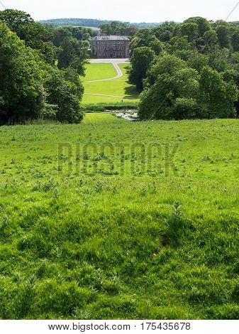 A manor in the distance at a green park at Donneraille in Cork County Ireland.