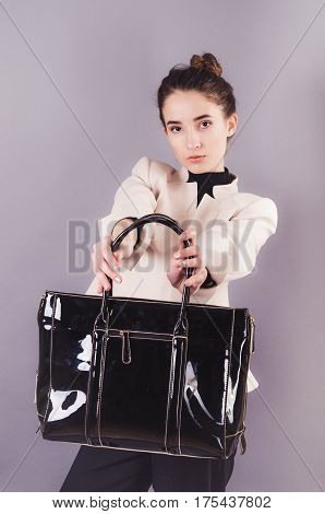 Front View Of A Young Smiling Business Woman With Ladies Bag.