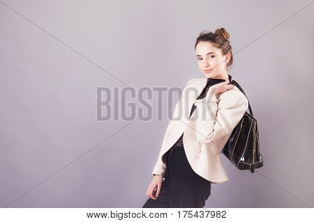 Front View Of A Young Smiling Business Woman With Ladies Bag.