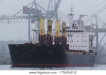 MERCHANT VESSEL - ship sets sail from the port in mist