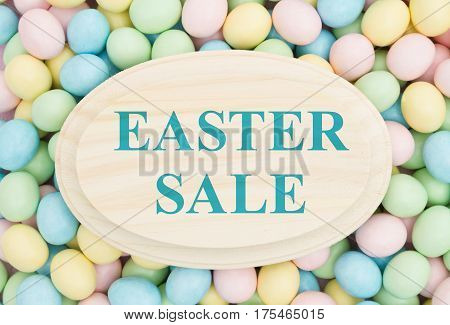 An ad for an Easter sale Retro Easter eggs candy on wood plaque with text Easter Sale