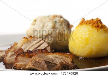 closeup of bavarian roasted pork with dumplings