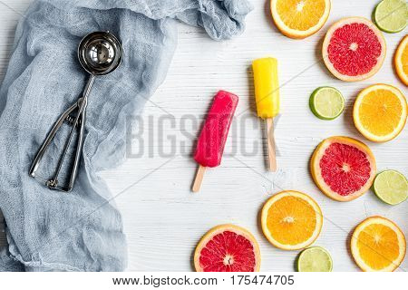 Homemade orange ice cream with fresh fruits on stone table background top view