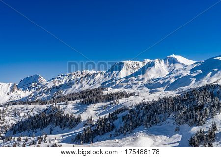 Beautiful Mountains In Snow. Evening Aerial View With Shadows.