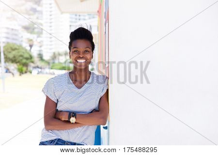 Confident Young Woman Smiling Against Shite Wall