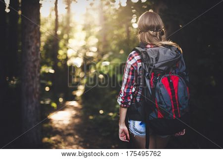Female backpacker set out on forest hike advanture